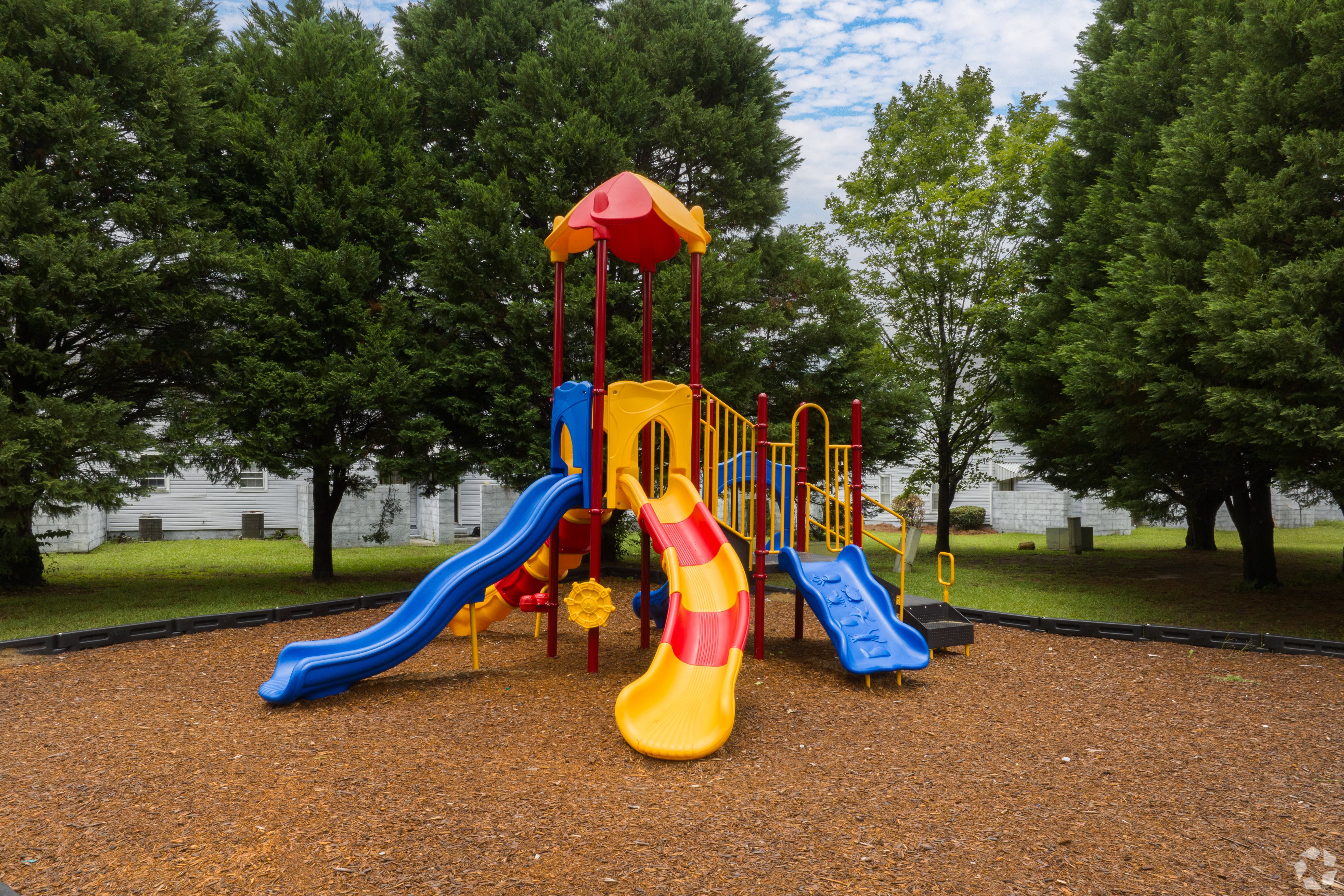 a colorful playground with slides and monkey bars